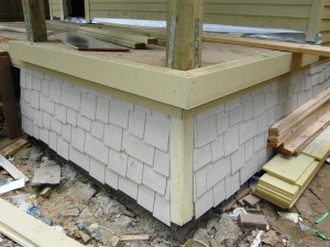 Shingle-style skirt being installed on porch of 1017A Waverly